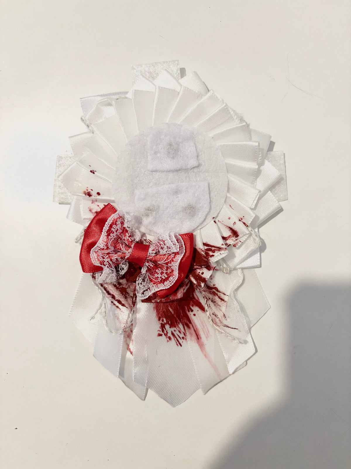 white blood-stained rosette